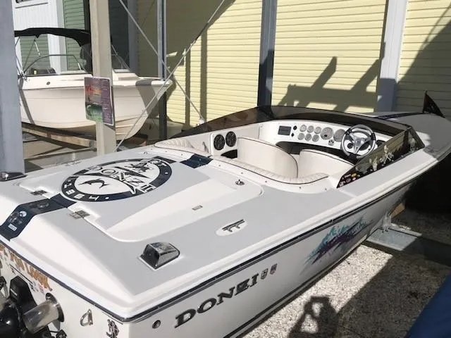 Slide: The Image of 2018 Donzi 22 Classic speedboat with sleek design, white exterior, and modern dashboard. - 3