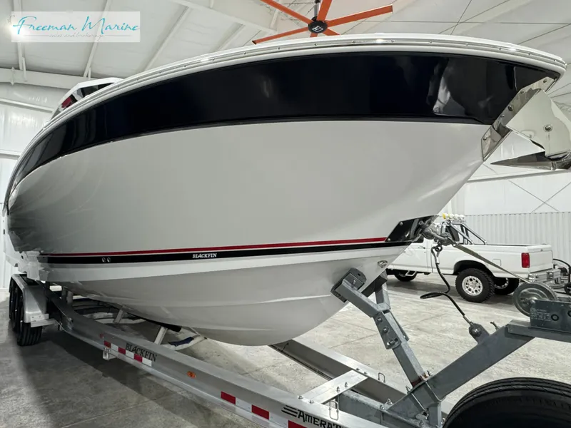 Slide: The Image of 2022 Blackfin 332 CC boat on trailer in indoor storage facility. - 17