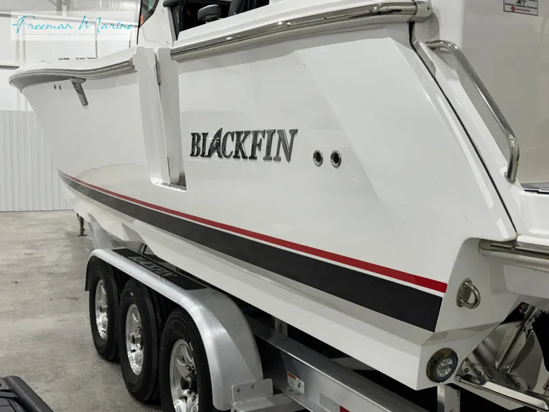 Slide: The Image of 2022 Blackfin 332 CC boat on trailer, side view in a garage. - 20