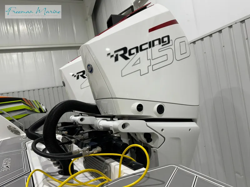 Slide: The Image of 2022 Blackfin 332 CC with Racing 450 outboard engines in a showroom. - 22