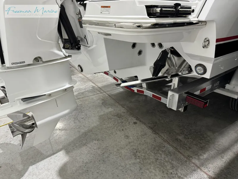 Slide: The Image of 2022 Blackfin 332 CC boat on trailer, showcasing dual outboard motors. - 23