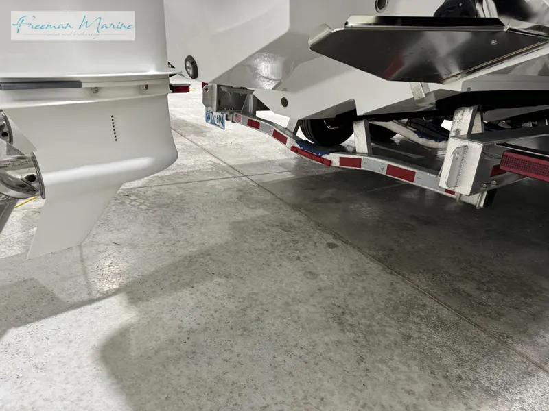 Slide: The Image of 2022 Blackfin 332 CC boat on trailer, showcasing engine and hull details. - 24