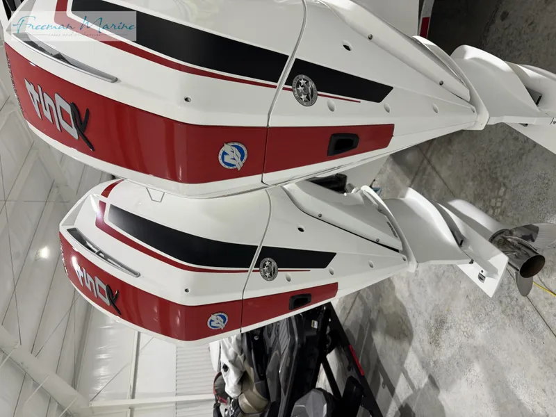 Slide: The Image of Twin outboard engines on a 2022 Blackfin 332 CC boat in a showroom. - 26