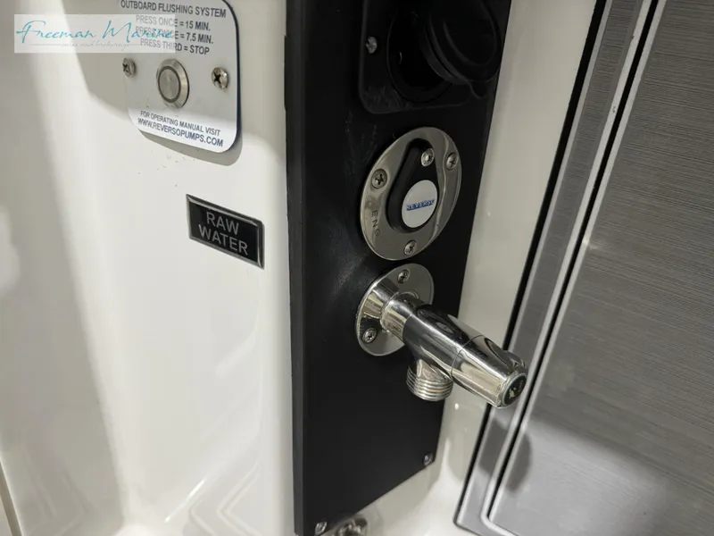 Slide: The Image of 2022 Blackfin 332 CC raw water outlet and control panel. - 42