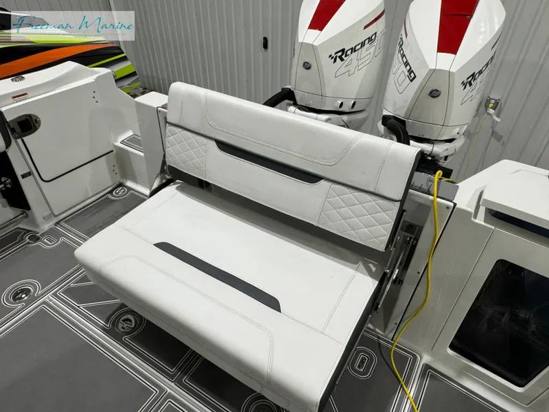 Slide: The Image of 2022 Blackfin 332 CC boat interior with white seating and twin outboard engines. - 44
