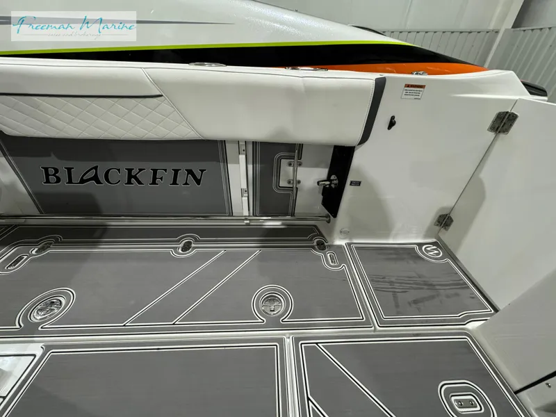 Slide: The Image of 2022 Blackfin 332 CC boat interior with sleek flooring and branding. - 45