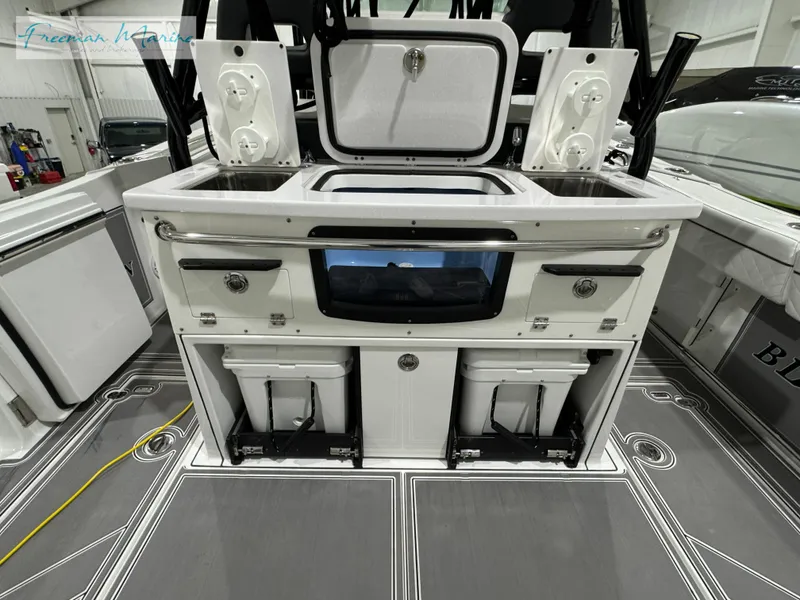 Slide: The Image of 2022 Blackfin 332 CC boat interior with storage compartments and fishing equipment. - 47