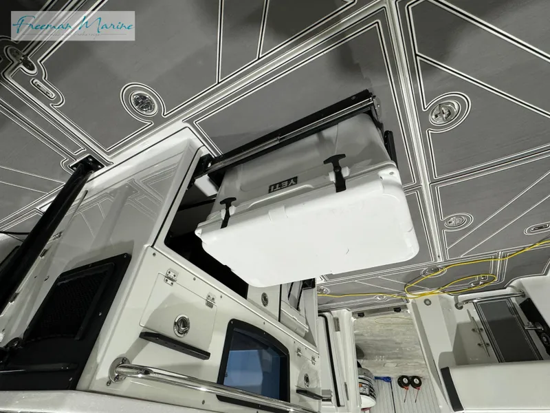 Slide: The Image of 2022 Blackfin 332 CC boat interior with mounted cooler and sleek design. - 48