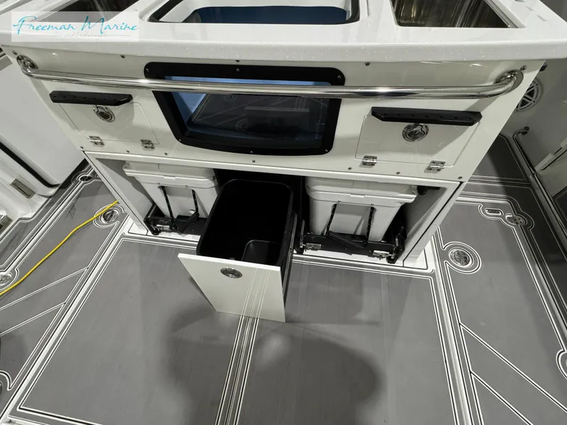 Slide: The Image of 2022 Blackfin 332 CC boat interior with storage compartments and sleek design. - 49