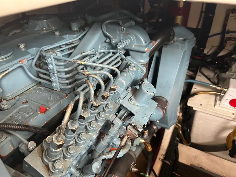 Slide: The Image of Engine compartment of a 1997 Tiara Yachts 3500 Express, showcasing detailed mechanical components. - 12