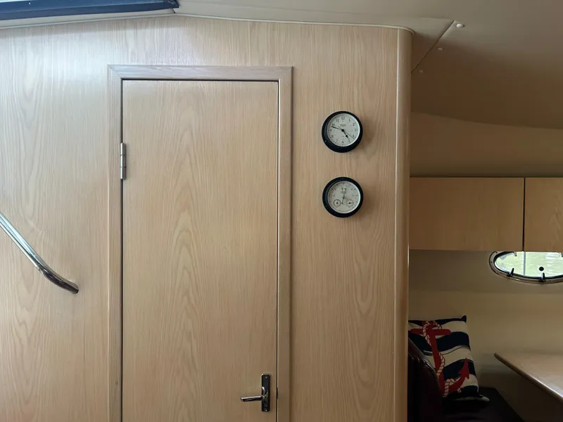 Slide: The Image of Interior of 1997 Tiara Yachts 3500 Express with wooden door and nautical decor. - 21