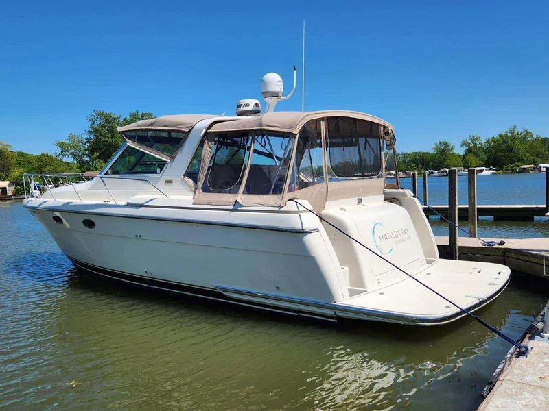 Slide: The Image of 1997 Tiara Yachts 3500 Express docked on a sunny day, featuring a sleek design. - 3