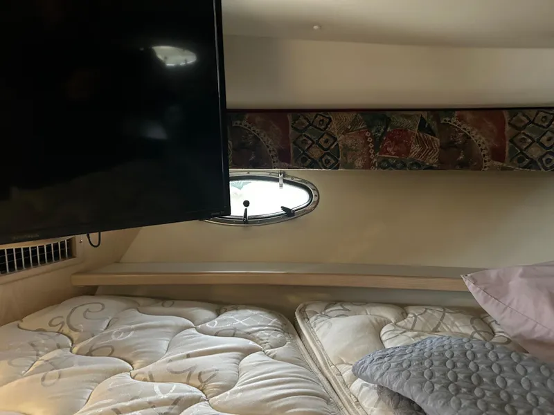 Slide: The Image of Interior cabin of 1997 Tiara Yachts 3500 Express with bed and TV. - 33