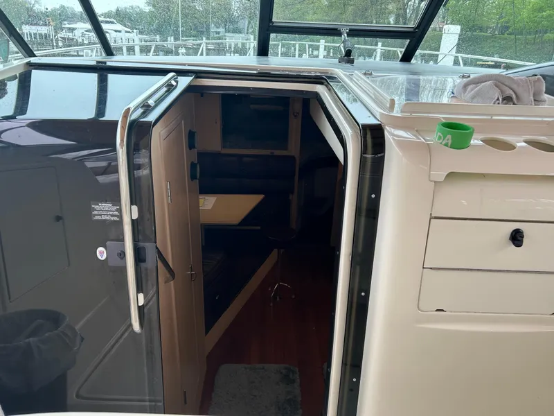 Slide: The Image of 1997 Tiara Yachts 3500 Express cabin entrance with open door and interior view. - 34