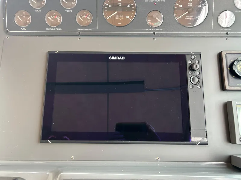 Slide: The Image of Simrad display on 1997 Tiara Yachts 3500 Express dashboard with gauges. - 37