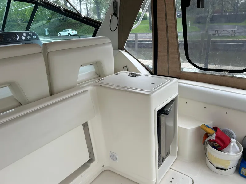 Slide: The Image of 1997 Tiara Yachts 3500 Express interior with seating and mini fridge. - 40