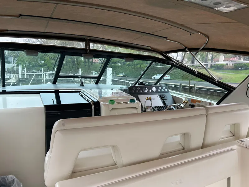 Slide: The Image of 1997 Tiara Yachts 3500 Express interior with helm and seating area. - 44