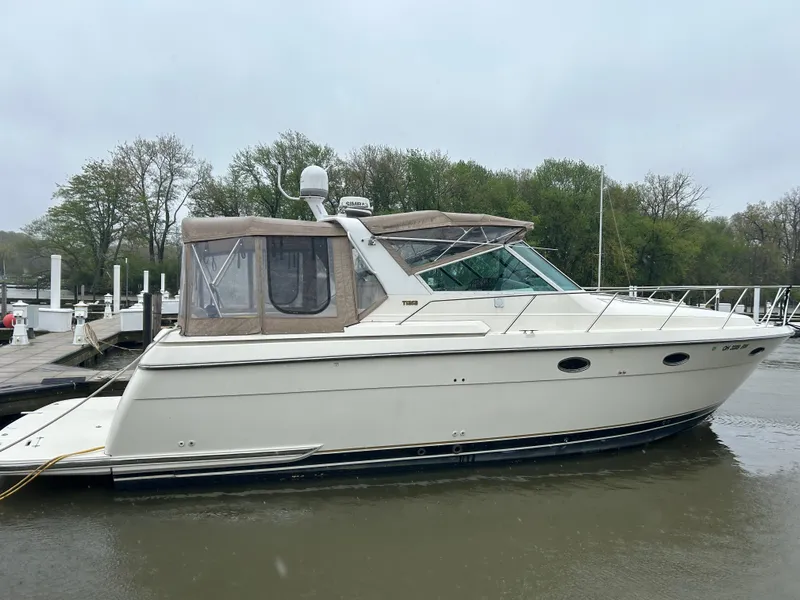 Slide: The Image of 1997 Tiara Yachts 3500 Express docked on a calm, overcast day. - 7