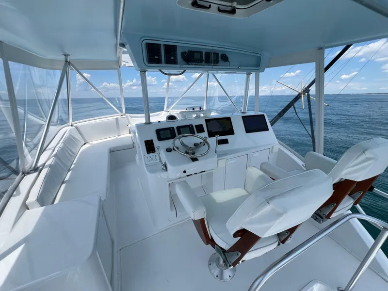 Slide: The Image of 2001 Ocean 52 Convertible yacht helm with ocean view, featuring modern navigation equipment. - 10