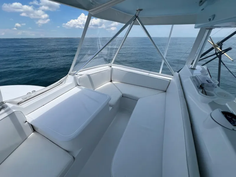 Slide: The Image of 2001 Ocean 52 Convertible yacht interior with ocean view and white seating. - 11