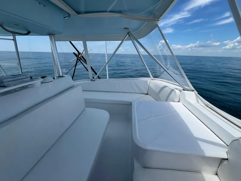 Slide: The Image of Ocean 52 Convertible 2001 yacht interior with ocean view and white seating. - 13