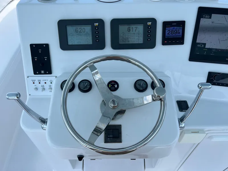 Slide: The Image of Steering wheel and controls of 2001 Ocean 52 Convertible yacht. - 14