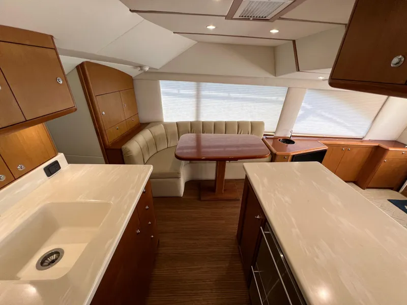 Slide: The Image of Interior of 2001 Ocean 52 Convertible yacht with kitchen and dining area. - 16