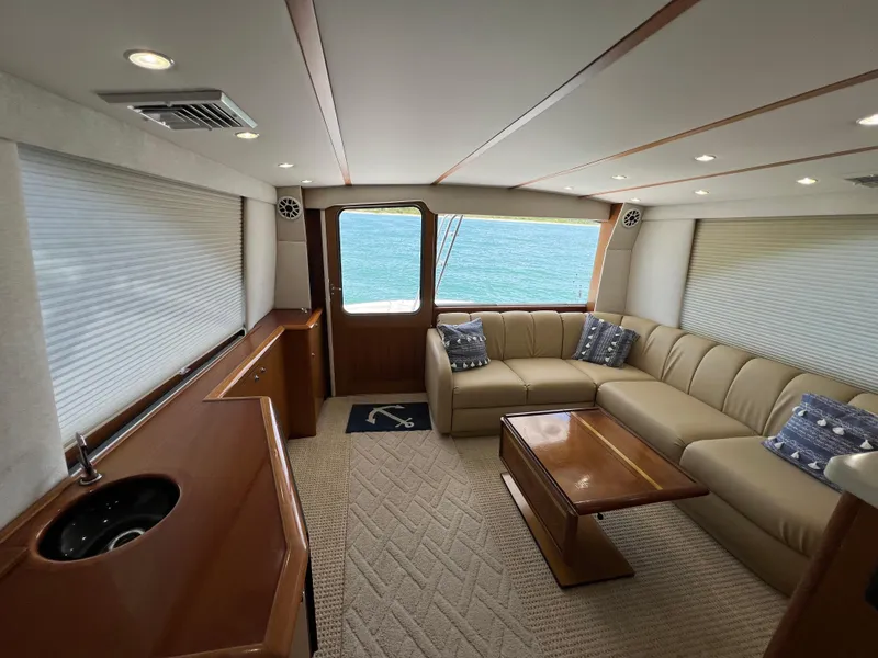 Slide: The Image of Luxurious interior of 2001 Ocean 52 Convertible yacht with beige seating and ocean view. - 19