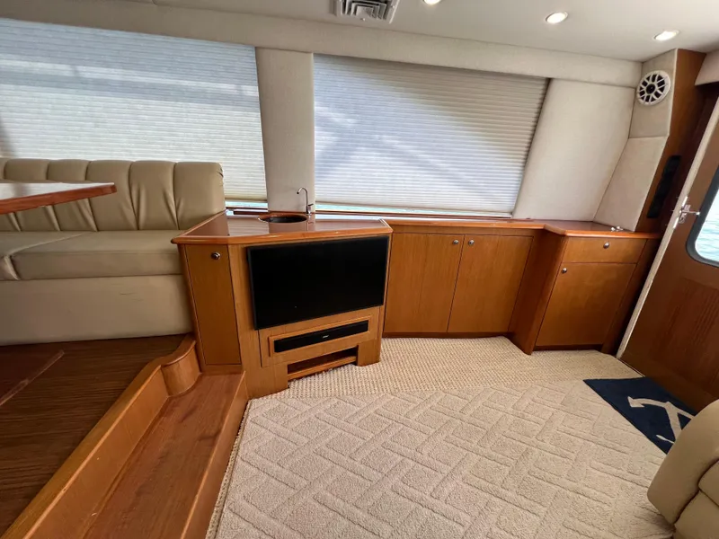 Slide: The Image of Interior of 2001 Ocean 52 Convertible yacht with wood cabinetry and plush seating. - 22