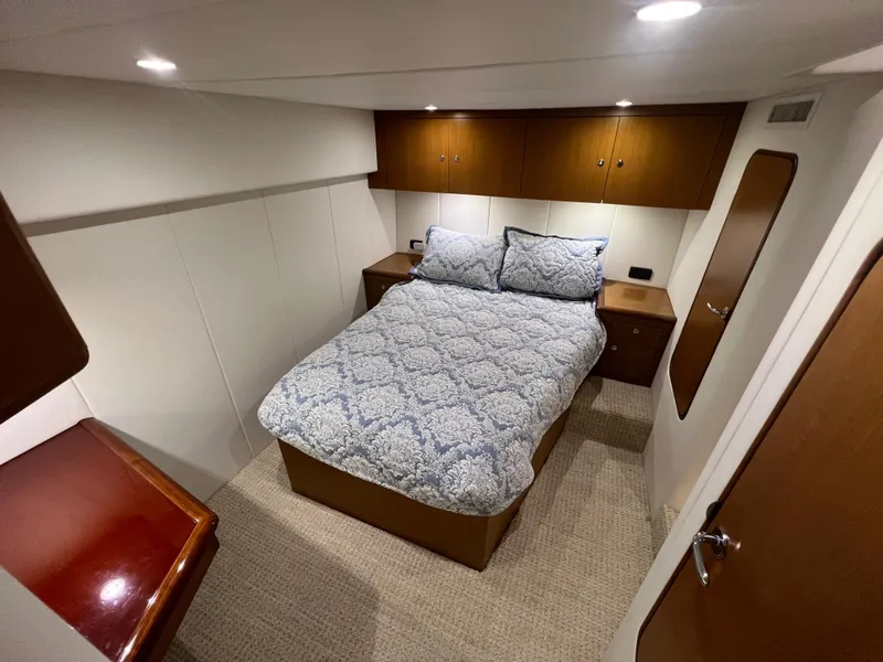 Slide: The Image of Cozy bedroom in 2001 Ocean 52 Convertible yacht with elegant wood accents. - 24