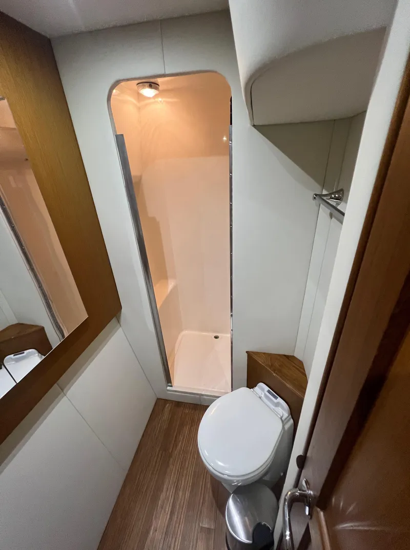 Slide: The Image of Bathroom interior of 2001 Ocean 52 Convertible yacht, featuring shower and toilet. - 26