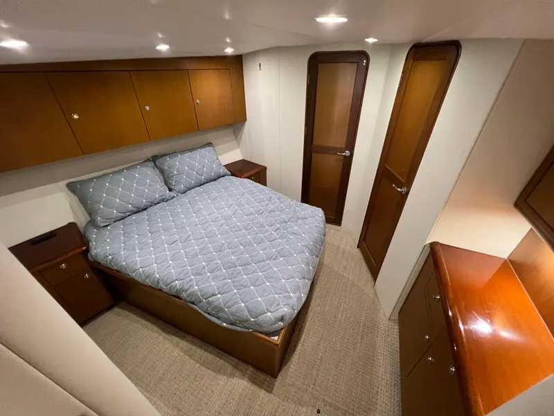 Slide: The Image of Luxurious bedroom in 2001 Ocean 52 Convertible yacht with wood cabinetry and cozy bedding. - 28
