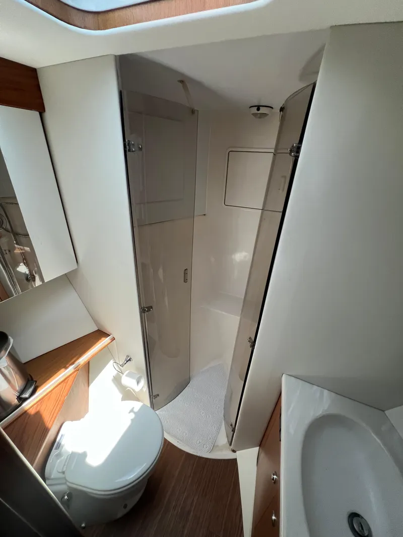 Slide: The Image of Bathroom interior of 2001 Ocean 52 Convertible yacht, featuring shower and sink. - 30