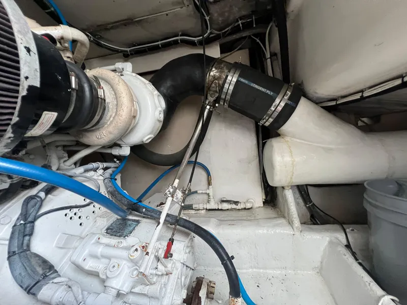 Slide: The Image of Engine compartment of 2001 Ocean 52 Convertible boat with visible hoses and components. - 33