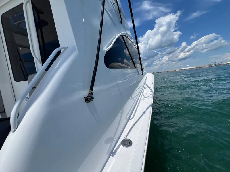 Slide: The Image of Side view of 2001 Ocean 52 Convertible yacht on open water under blue sky. - 37