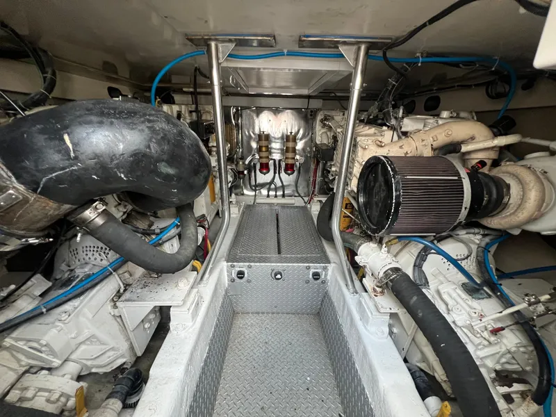Slide: The Image of Engine room of 2001 Ocean 52 Convertible yacht, showcasing mechanical components and piping. - 40
