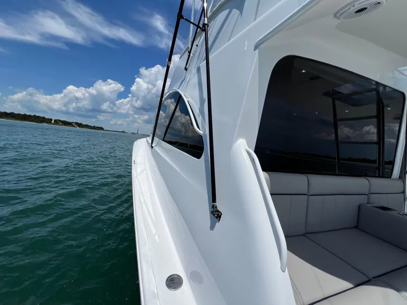 Slide: The Image of Ocean 52 Convertible yacht, 2001 model, cruising on clear blue waters under a sunny sky. - 46