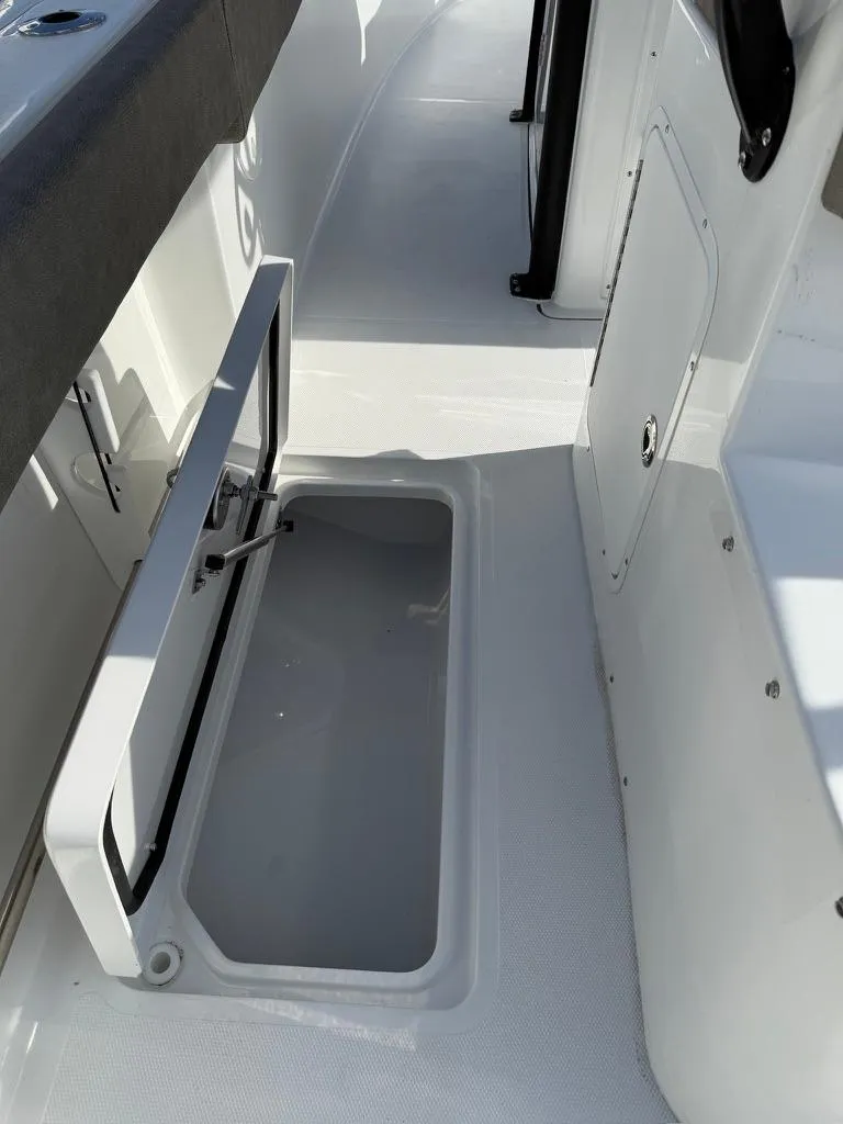 Slide: The Image of 2025 Sea Hunt Gamefish 28 boat interior with open coffin box storage. - 14
