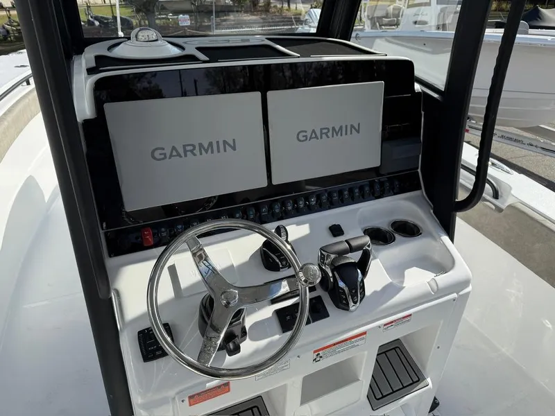 Slide: The Image of 2025 Sea Hunt Gamefish 28 helm with dual Garmin displays and steering wheel. - 8