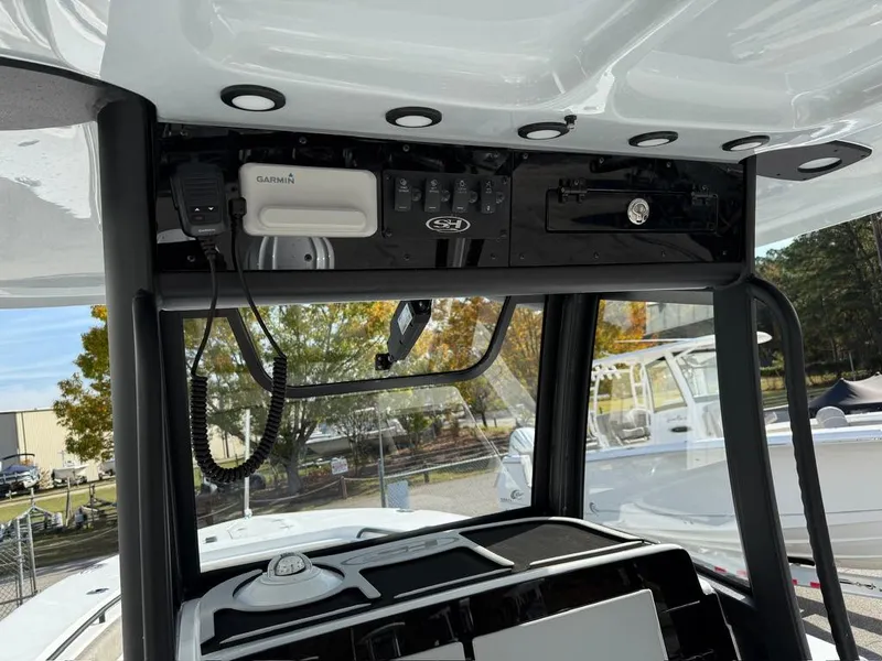 Slide: The Image of 2025 Sea Hunt Gamefish 28 console with electronics and storage compartments. - 9