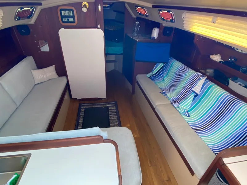 Slide: The Image of Interior of 1988 Catalina 30 sailboat with cozy seating and wooden accents. - 10