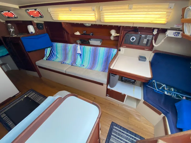 Slide: The Image of Interior of 1988 Catalina 30 sailboat with cozy seating and nautical decor. - 11