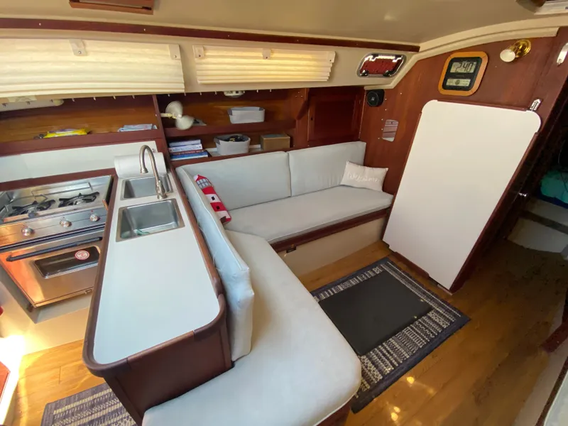 Slide: The Image of Interior of 1988 Catalina 30 sailboat with kitchen and seating area. - 12