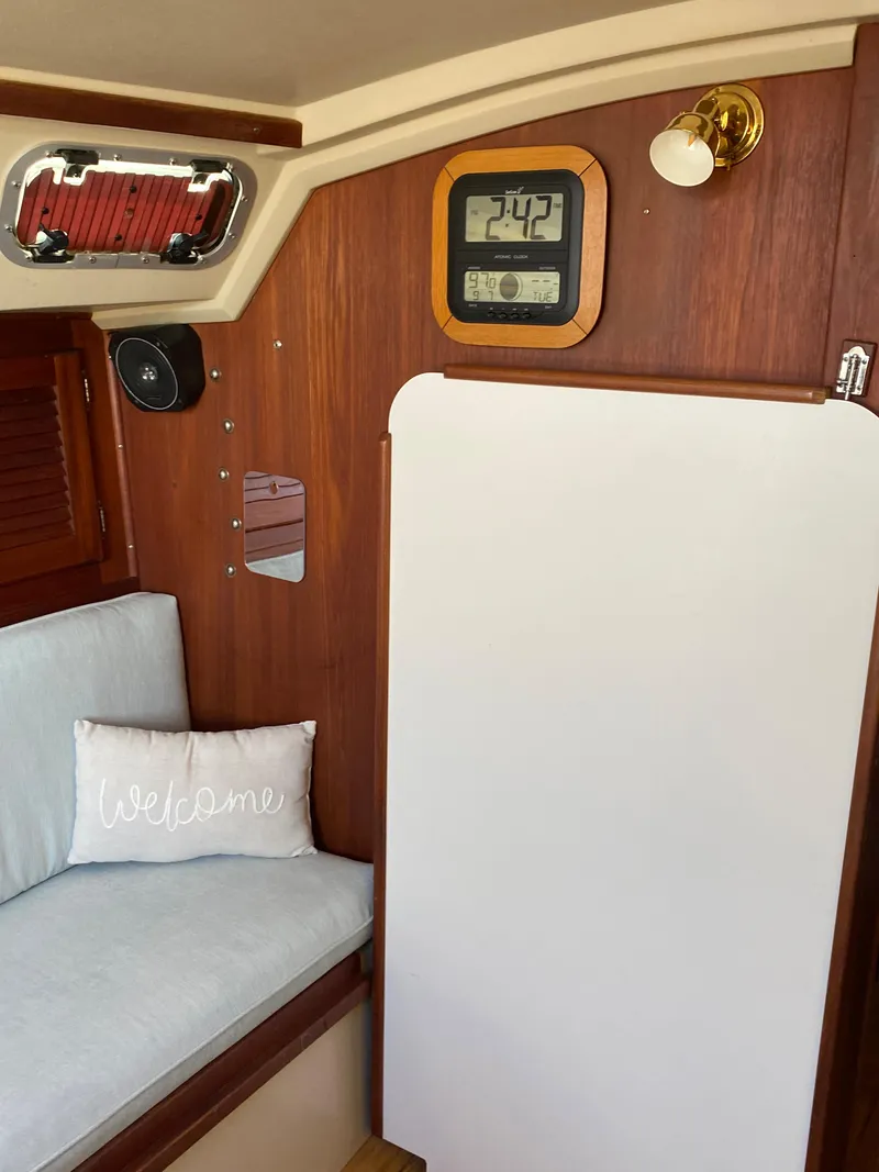 Slide: The Image of Interior of 1988 Catalina 30 sailboat with cozy seating and nautical decor. - 13