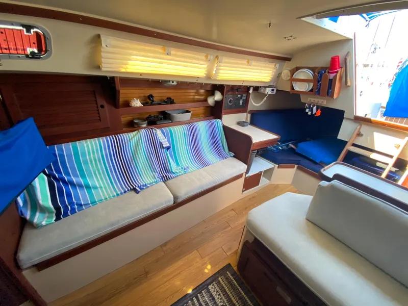 Slide: The Image of Interior of a 1988 Catalina 30 sailboat with cozy seating and nautical decor. - 16