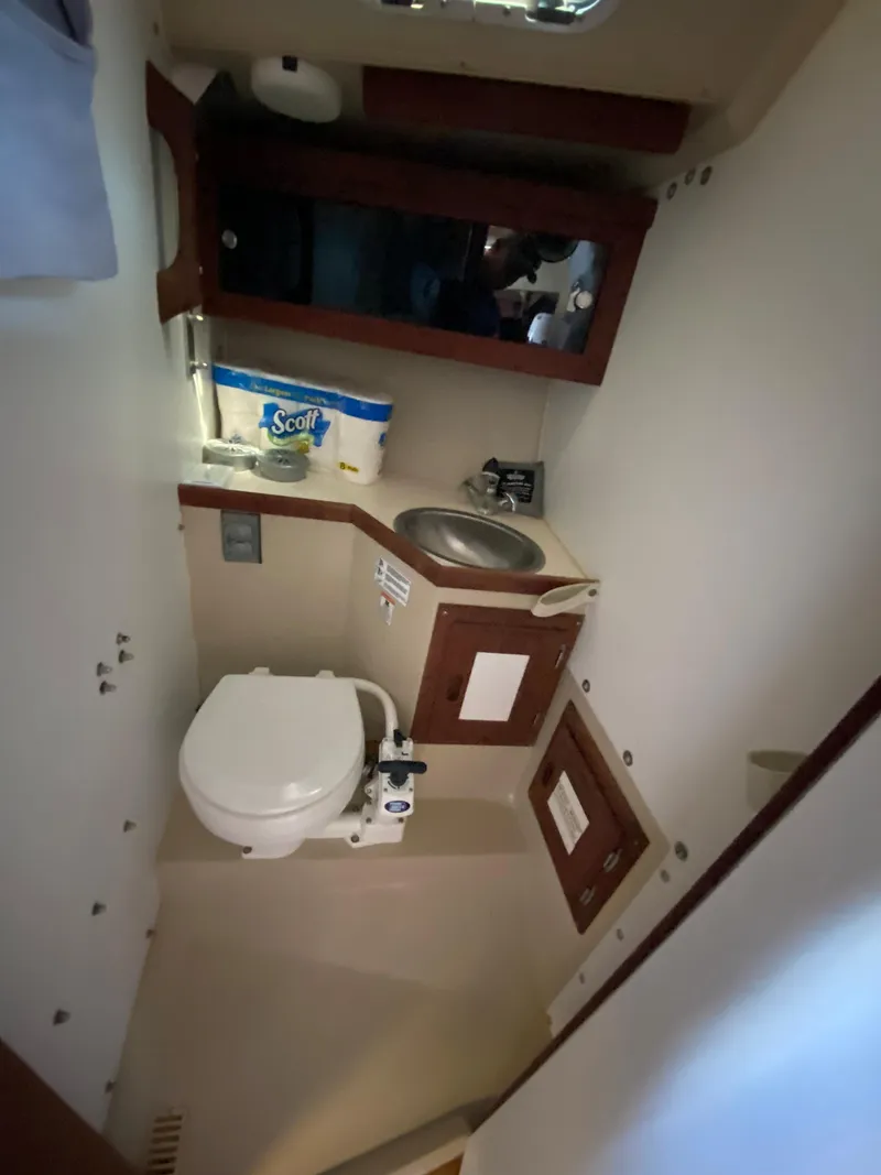Slide: The Image of Compact bathroom in 1988 Catalina 30 sailboat with toilet, sink, and storage. - 19