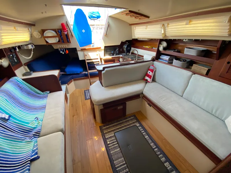 Slide: The Image of Interior of 1988 Catalina 30 sailboat with cozy seating and nautical decor. - 21