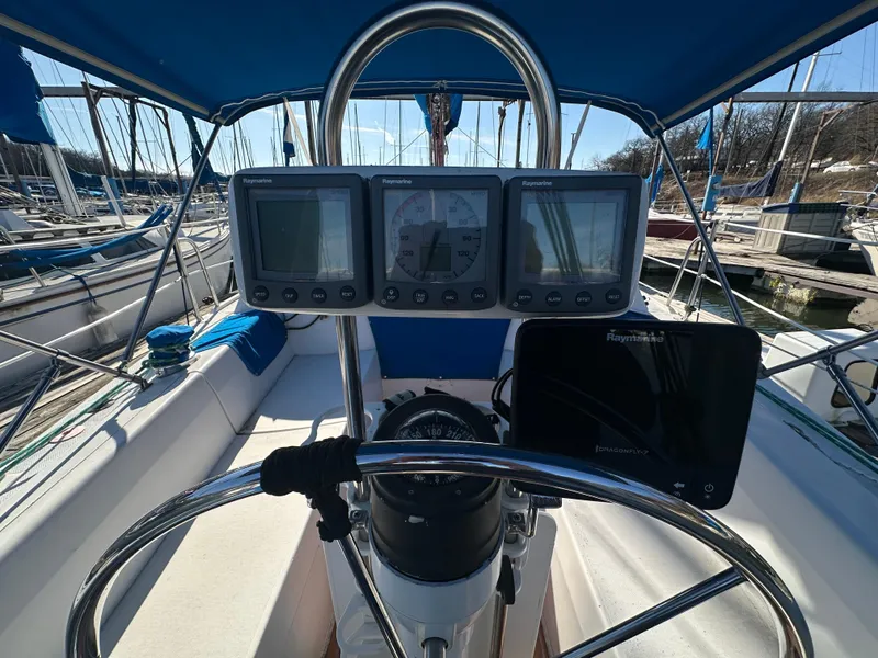Slide: The Image of Cockpit of 1988 Catalina 30 sailboat with navigation instruments and steering wheel. - 6