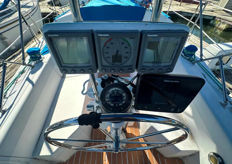 Slide: The Image of Cockpit of 1988 Catalina 30 sailboat with navigation instruments and steering wheel. - 7