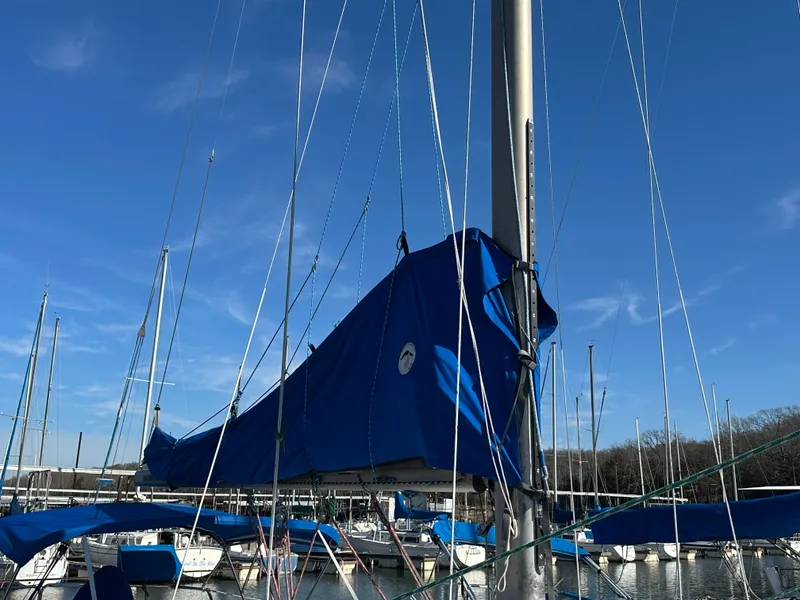 Slide: The Image of 1988 Catalina 30 sailboat with blue sail cover docked at marina. - 9